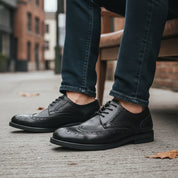 model-siting - Men's Black Leather Wingtip Brogues
