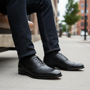 model-siting - Men's Black Ostrich Leather Wingtip Shoes
