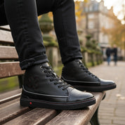 model-siting - Unisex Black Leather Biker Sneakers