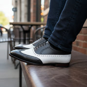 Black and White Leather Brogue Dress Shoes - model-sitting-bench