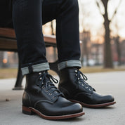 Men's Black Leather Ankle Boots with Lace-Up Design - model-sitting-bench