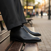 Men's Black Leather Oxford Dress Shoes - model-sitting-bench