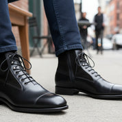 Men's Black Leather Ankle Boots with Cap Toe - model-sitting-bench