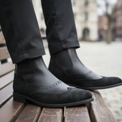 Men's Black Leather Chelsea Boots - model-sitting-bench