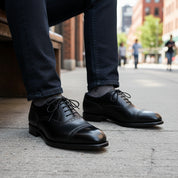Men's Black Leather Brogue Oxford Shoes - model-sitting-bench