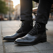 Men's Black Leather Wingtip Brogue Boots - model-sitting-bench