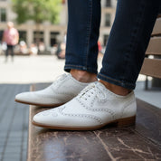 Men's White Leather Wingtip Brogue Dress Shoes - model-sitting-bench