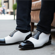 Men's Black and White Spectator Dress Shoes - model-sitting-bench