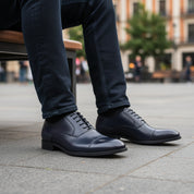 model-sitting-bench - Men's Black Leather Cap Toe Dress Shoes