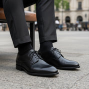 Men's Black Leather Dress Oxfords - model-sitting-bench