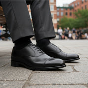 Men's Black Leather Lace-Up Oxfords - model-sitting-bench