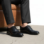 model-sitting-bench - Men's Black Leather Oxford Wingtip Dress Shoes