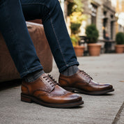 model-sitting-bench - Men's Black Leather Wingtip Oxfords