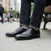 Men's Black Oxford Leather Dress Shoes - model-sitting-bench