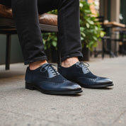 Men's Black Suede & Leather Wingtip Shoes - model-sitting-bench