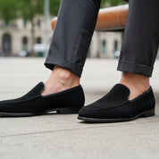 Men's Black Suede Penny Loafers - model-sitting-bench