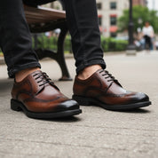 model-sitting-bench - Men's Brown Leather Wingtip Oxfords