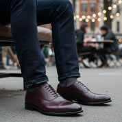 model-sitting-bench - Men's Dark Maroon Leather Oxford Dress Shoes