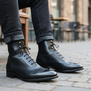 Men's Navy Blue Wingtip Brogue Leather Boots - model-sitting-bench