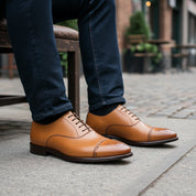 Men's Tan Leather Dress Shoes with Lace-up Closure - model-sitting-bench