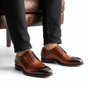 model-sitting-bench - Men's Tan Leather Wingtip Dress Shoes