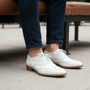 Men's White Wingtip Brogue Leather Dress Shoes - model-sitting-bench