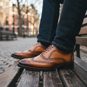 Men's Tan Leather Wingtip Oxford Dress Shoes - model-sitting-bench